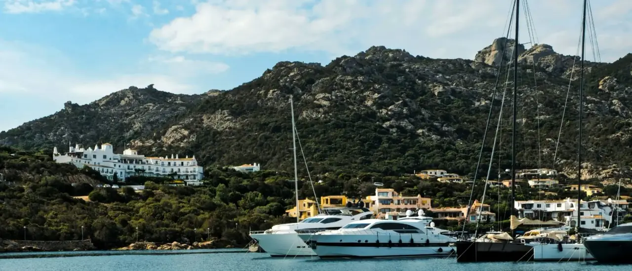 Marina di Porto Cervo con yacht ormeggiati e colline della Costa Smeralda